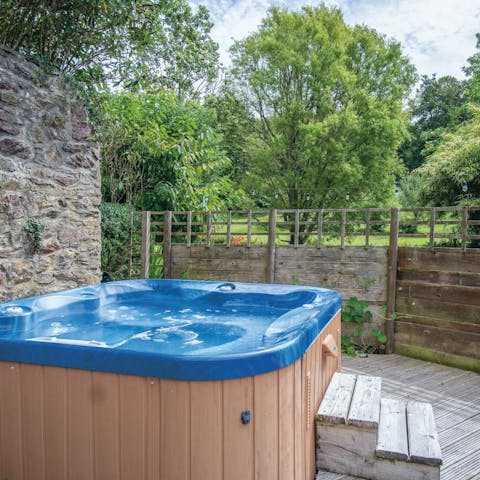 Soak in the hot tub with a glass of bubbly