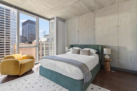 Wake up to sun-kissed skyscrapers in the main bedroom