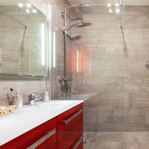 Relax and unwind beneath the bathroom's luxurious rainfall shower
