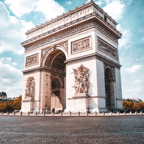 Visit the Arc de Triomphe, under half an hour walk or a ten-minute ride away