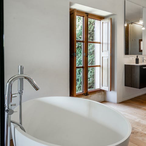 Relax sore muscles with a soak in the free-standing bathtub