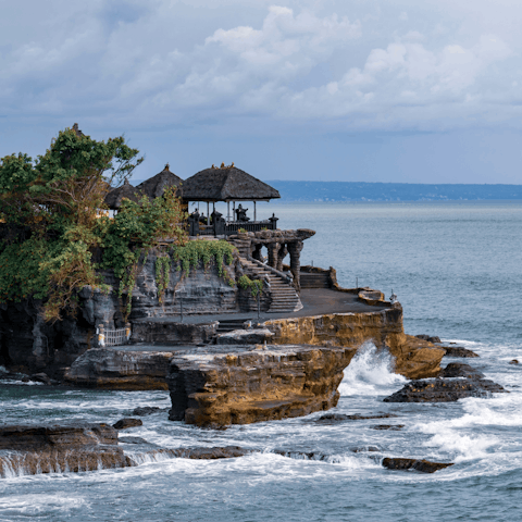 Visit the impressive Tanah Lot temple – a fifteen-minute drive away