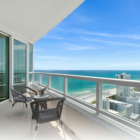 Admire the ocean view from the balcony with a glass of bubbly
