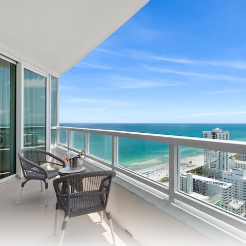 Admire the ocean view from the balcony with a glass of bubbly