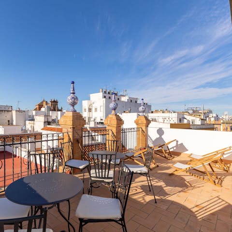 Admire the views of Seville from the shared terrace