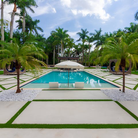 Go for a dip in the private pool surrounded by palm trees
