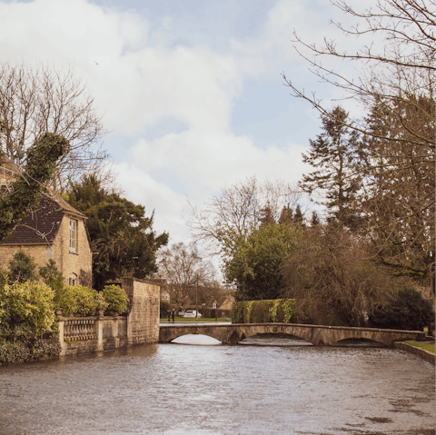 Drive twenty minutes to Bourton-on-the-Water for classic Cotswolds charm