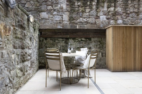 Share a bottle of wine against ancient Edinburgh stonework