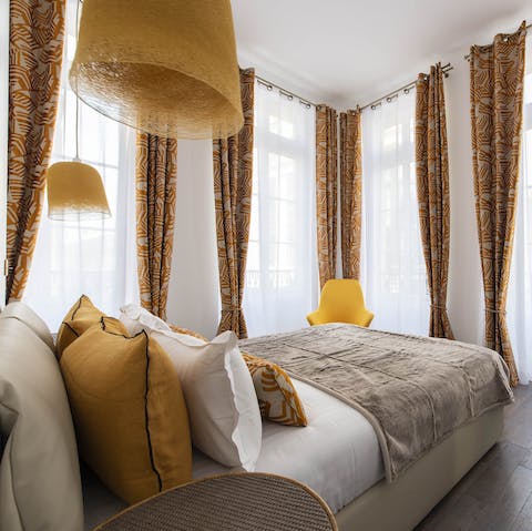 Wake up to beautiful floor-to-ceiling views of the Marais in the stylish bedroom
