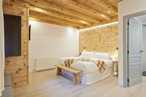 Retreat to a cosy, Alpine-styled room after a day on the slopes