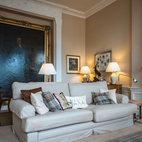 Relax on the sofa with a book from your host's collection