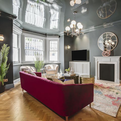 Sprawl out on the magenta-coloured sofa