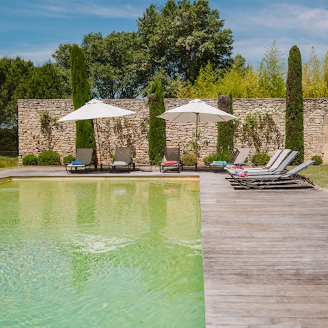 Grab a book and unwind by the outdoor swimming pool