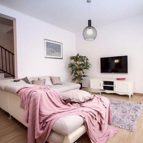 Sprawl out on the cosy sofa and play a game on the Playstation console