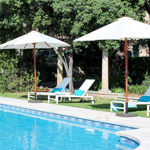Relax Spanish-style with a drink and a book by the private pool
