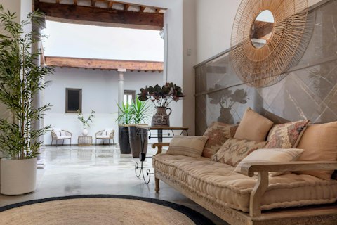 Curl up on soft cushions beside an open traditional courtyard