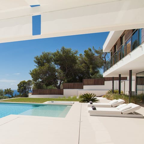Relax in the sunshine on a poolside lounger with a coffee and a good book