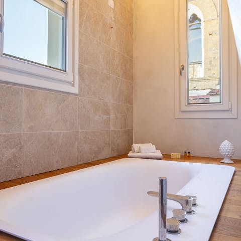 Have a relaxing soak in the sunken bathtub