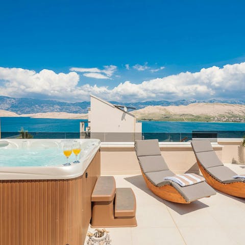 Chill on the sunbeds or soak in the hot tub with a sea view