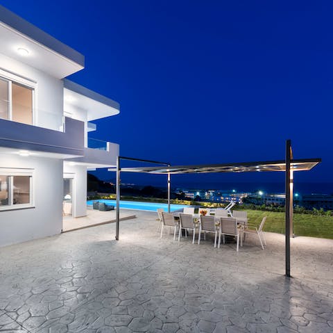 Gaze out at the glittering lights of Kolymbia from your private terrace