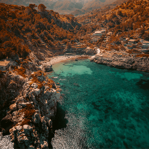 Lounge on the rocky shores of Cala Deia and swim in its crystal-clear waters