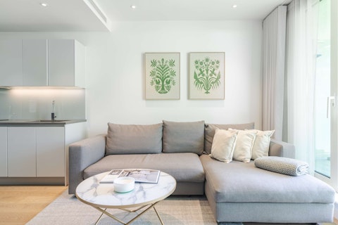 Sink into the corner sofa with treetop views