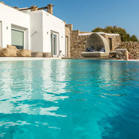 Swim laps in the turquoise waters of the private pool