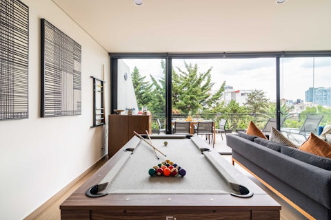 Challenge your fellow guests to a game of pool with the city skyline beyond