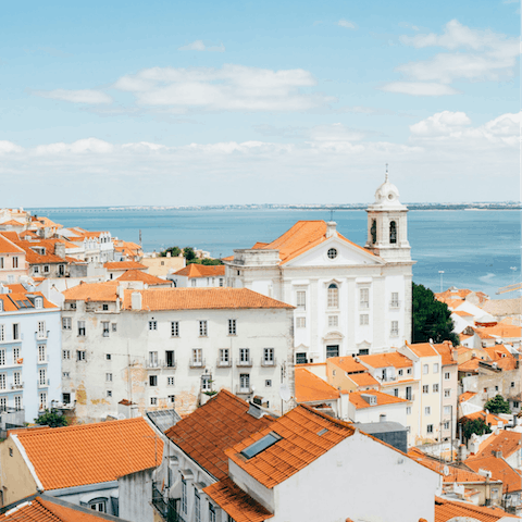 Watch a burning sunset from the Santa Luzia viewpoint, a five-minute walk away
