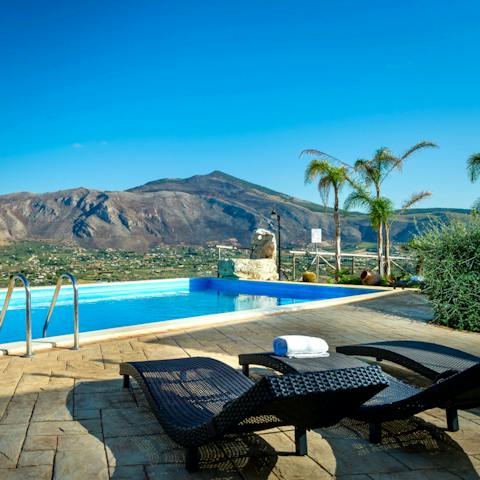 Relax and recline by the pool on the day beds