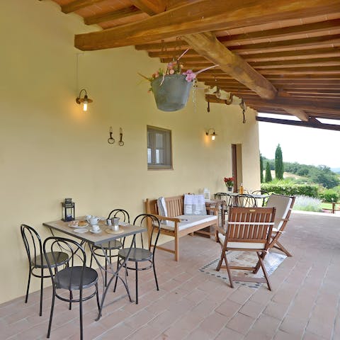 Hang out on the covered terrace, with places to lounge and feast together