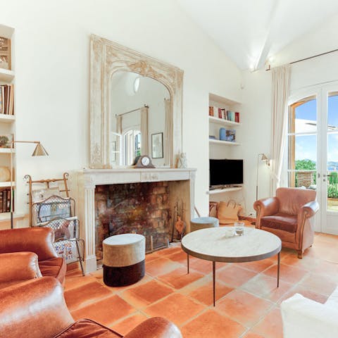 Share a bottle of wine by the elegant fireplace