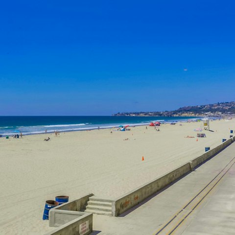 Take a stroll along Mission Beach and paddle in the shallow waters
