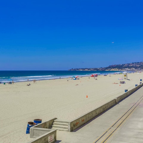 Take a stroll along Mission Beach and paddle in the shallow waters