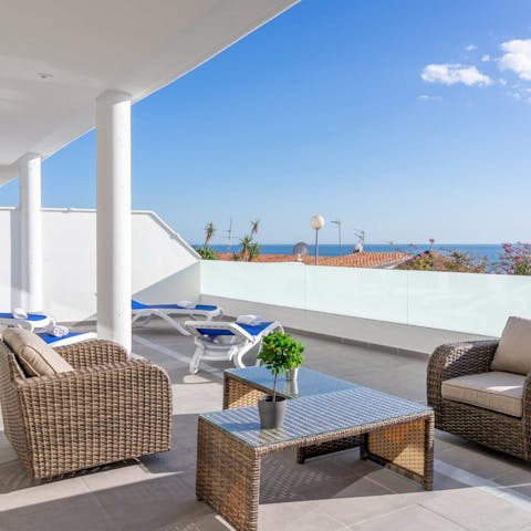 Stretch out on the balcony with your holiday read and a sangria