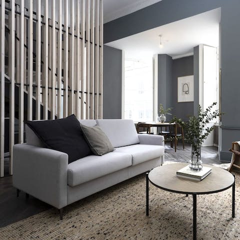 Relax in your chic living room with a glass of wine after a busy day of sightseeing