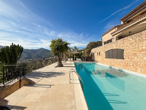 Swim in the palm-fringed pool, savouring the sunshine