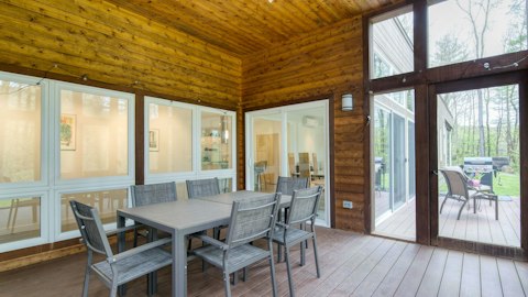 Enjoy outdoor meals beneath the timber-clad deck overlooking the trees