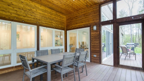 Enjoy outdoor meals beneath the timber-clad deck overlooking the trees