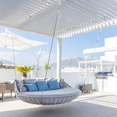 Turn the pages of your holiday read from the swing seat