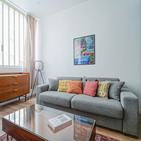 Unwind on the comfortable grey sofa in the stylish living room