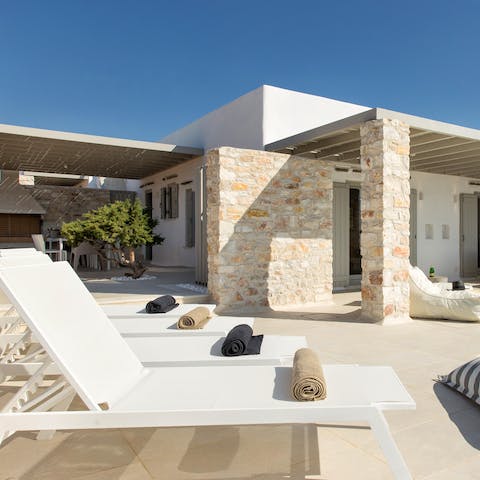 Catch some rays while lying on one of the poolside loungers