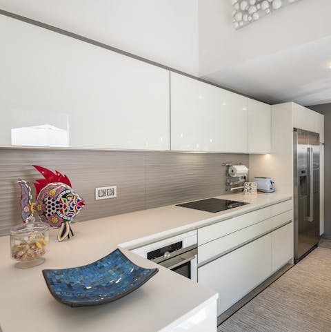 Serve up meals for the group in the sleek kitchen