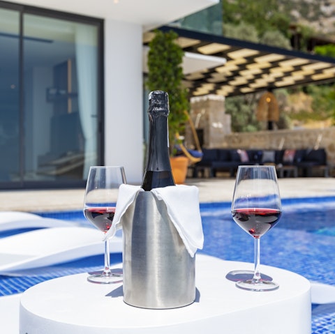 Make the most of your villa's dazzling pool by enjoying a glass of wine on the sun loungers