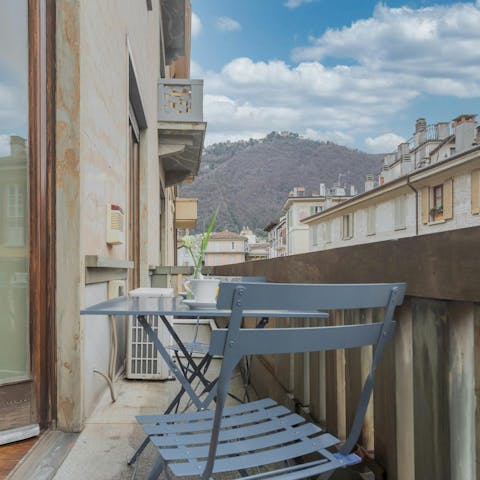Enjoy a glass of wine on the balcony overlooking Via Garibaldi