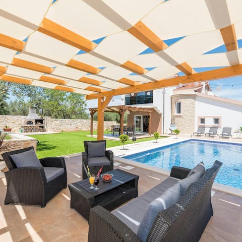 Sip chilled drinks in the shade by the pool