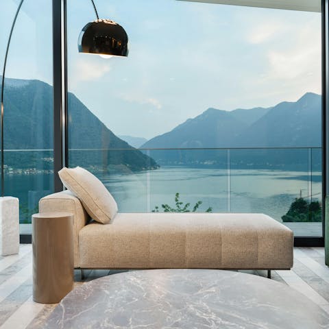 Take in the mountain and water vistas from the chaise longue
