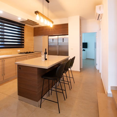 Serve glasses of Syrah at the sleek breakfast bar in the kitchen