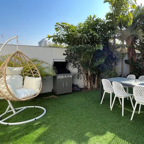 Curl up in the egg chair as the chef of the group tends to the barbecue