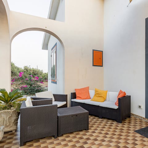 Enjoy the view of the surrounding fruit trees from the comfort of your own outdoor sofa